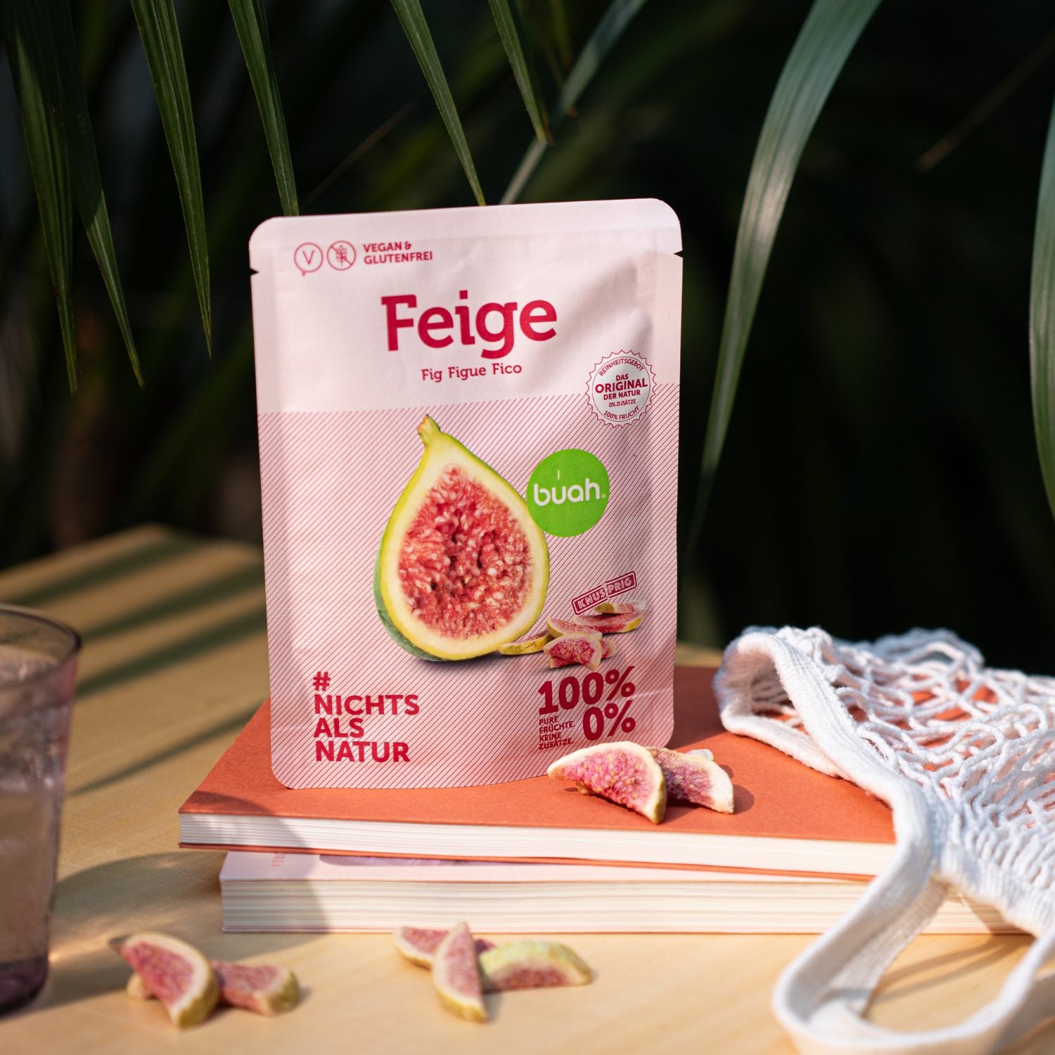 Snackpack buah Feige steht auf Buechern mit gefriergetrockneten Feigen davor