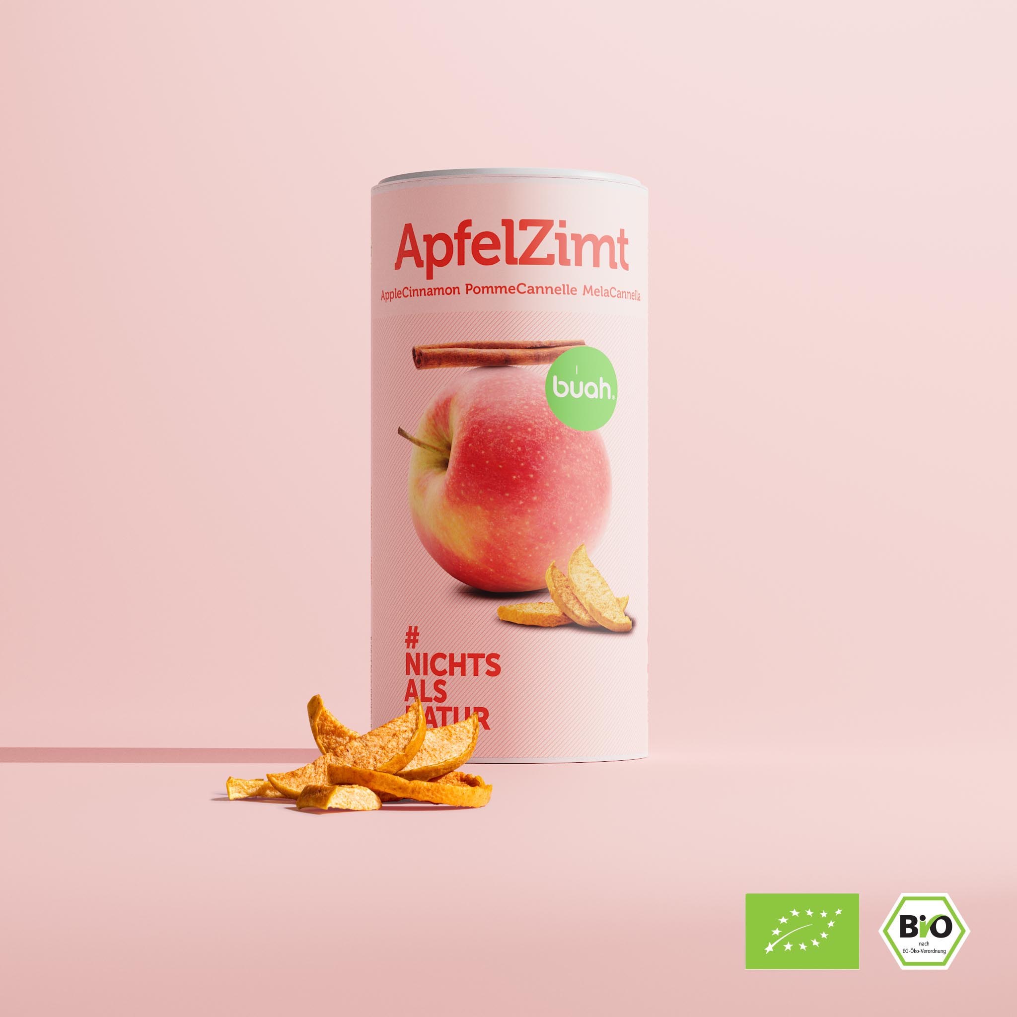 buah große Dose der neuen Sorte ApfelZimt, zylinder-foermige Dose vor rosa Hintergrund mit dem Abbild eines Apfels und einer Zimtstange, gefriergetrockneter Apfel vor der Dose