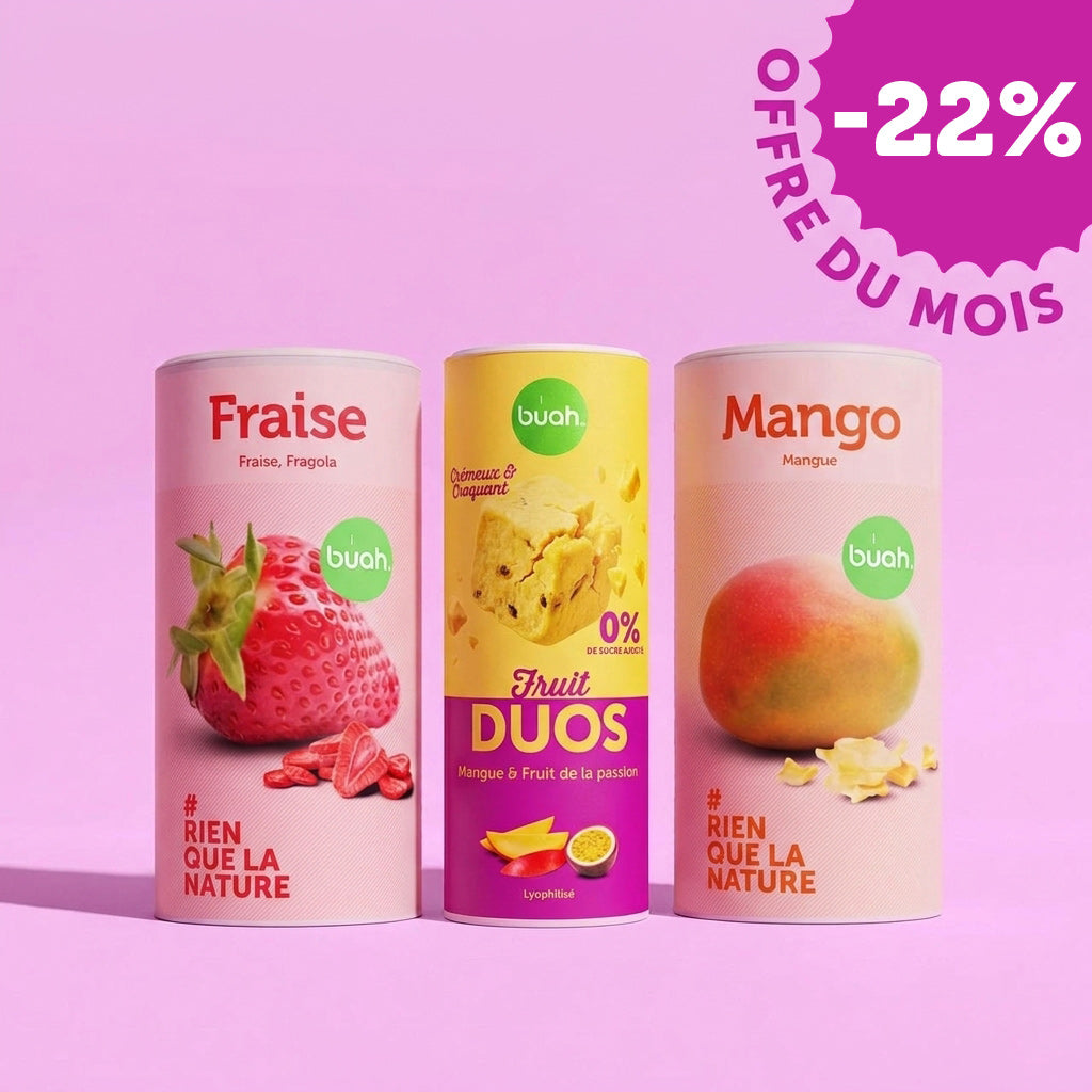 Trois grandes boîtes de fruits lyophilisés buah (fraise, kiwi doré, mangue) sont alignées sur un fond rose. En haut à droite se trouve un badge indiquant « -5% OFFERE DU MOIS".